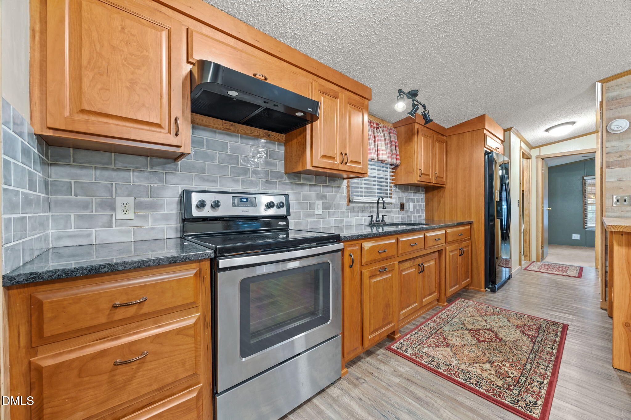 613 Will Lucas Road Linden, NC 28356 - Photo 77 of 98 a kitchen with stainless steel appliances granite countertop a stove a sink and a microwave