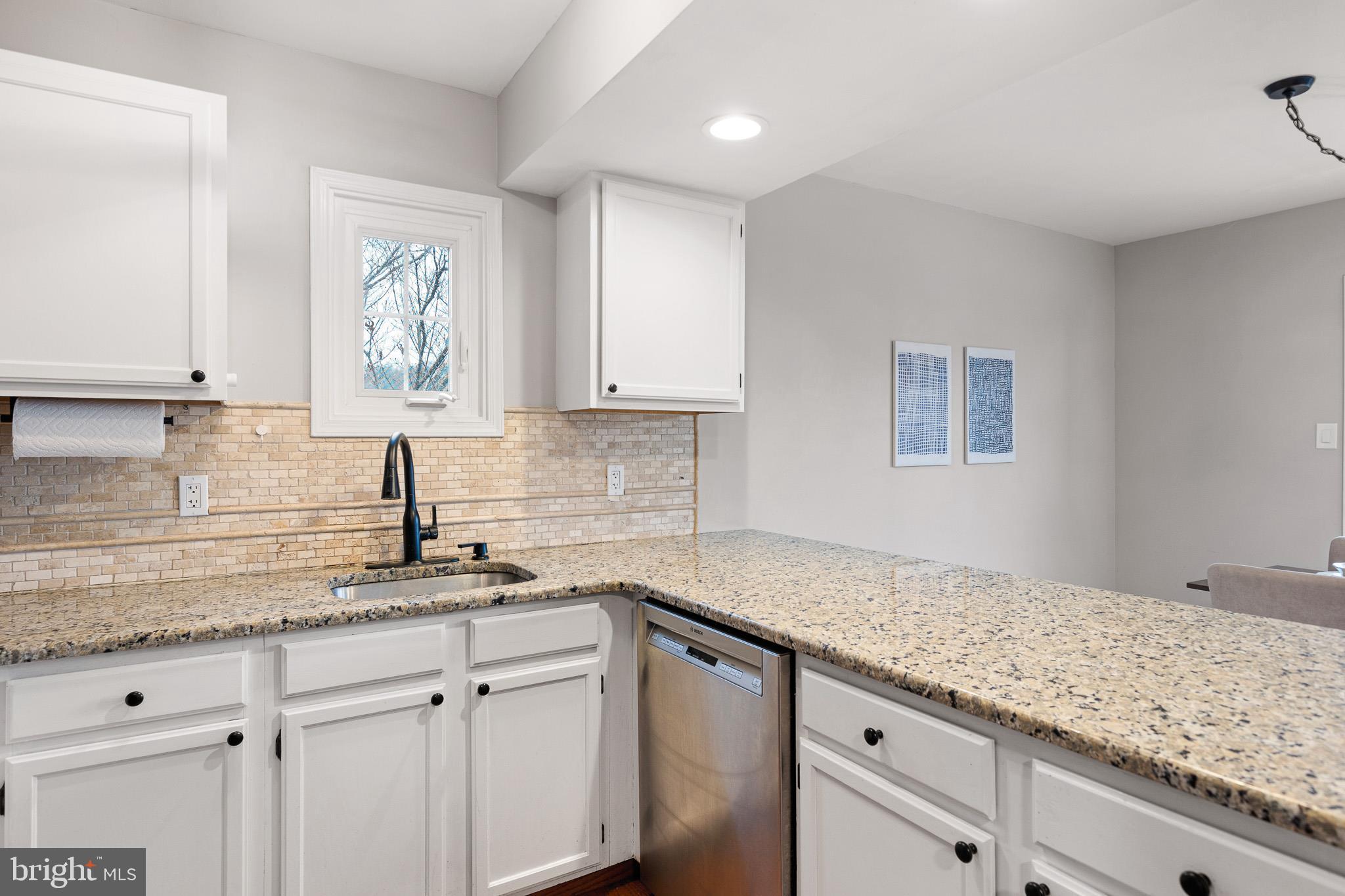 719 Jacques Circle Chester Springs, PA 19425 - Photo 11 of 31 a kitchen with granite countertop white cabinets and white appliances