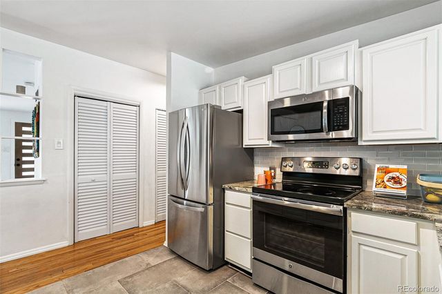 a kitchen with stainless steel appliances a refrigerator stove and microwave