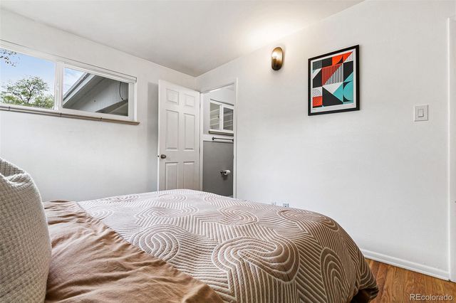 a bedroom with a bed and a painting on the wall