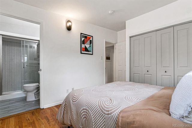 a bedroom with a white bed and a view of bathroom