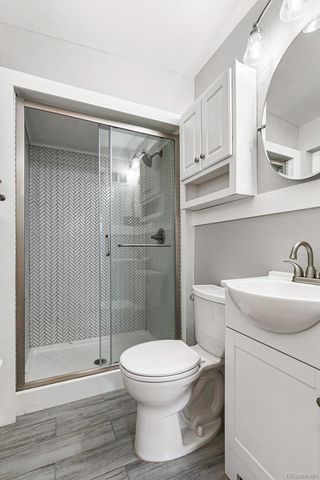 a bathroom with a toilet a sink and shower