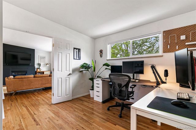 a view of a workspace with furniture and a flat screen tv