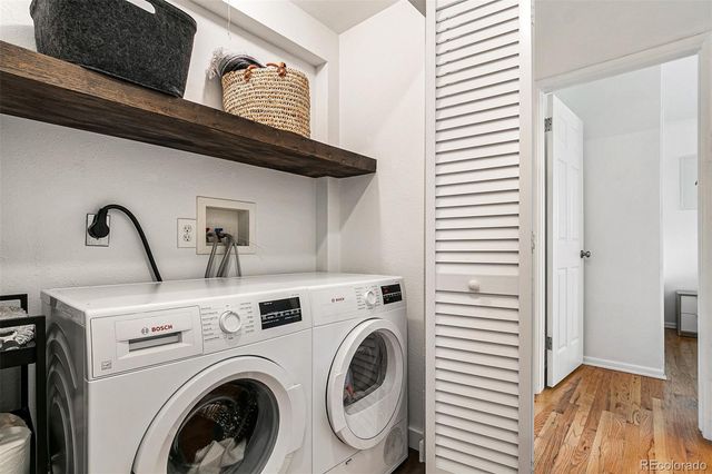 a view of washer and dryer with kitchen in the background
