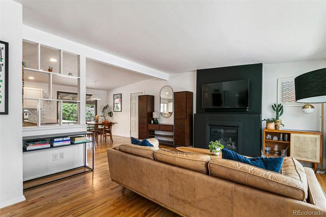 a living room with fireplace furniture and a flat screen tv