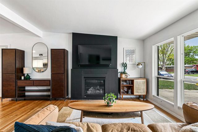 a living room with fireplace furniture and a fireplace