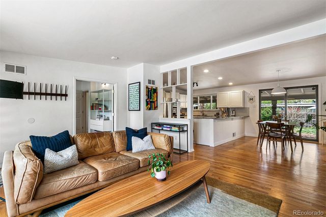 a living room with furniture and kitchen view