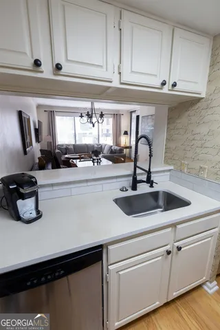 a kitchen with a sink and cabinets