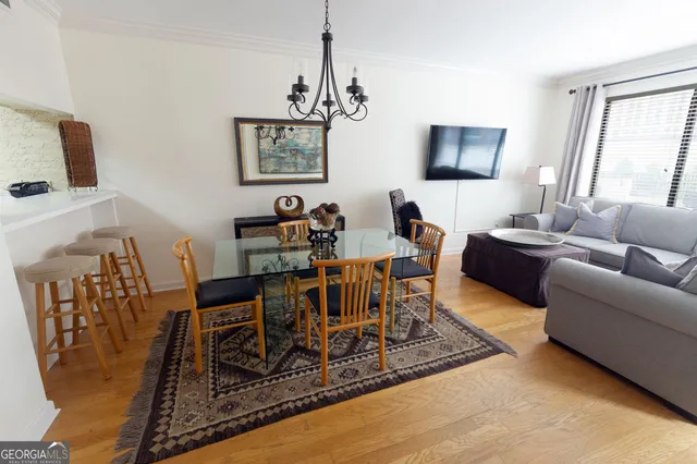 a living room with furniture a rug a lamp and a window