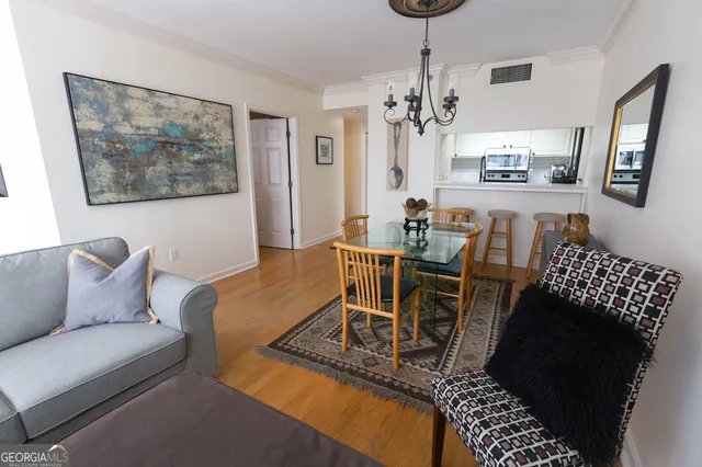 a living room with furniture and a chandelier