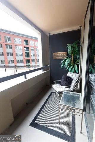 a living room with a couch and a potted plant