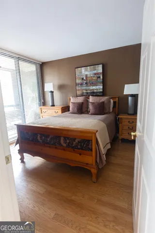 a bedroom with a bed and wooden floor