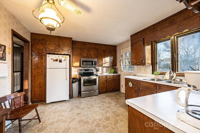 a kitchen with refrigerator cabinets and furniture