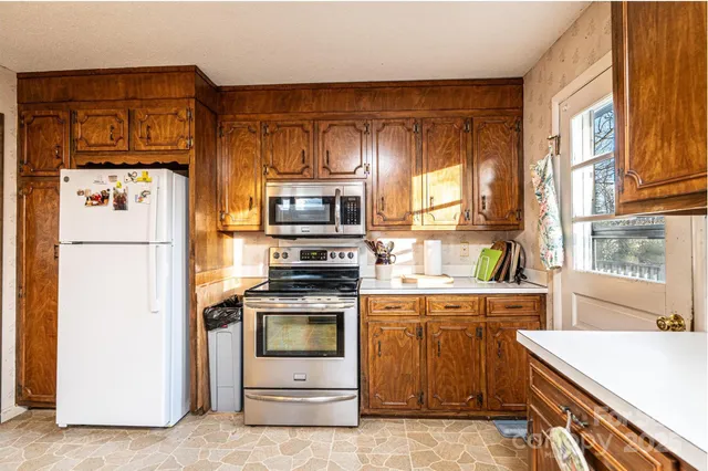 a kitchen with a stove a sink and a refrigerator