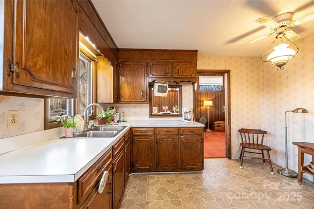 a kitchen with sink cabinets and dining table