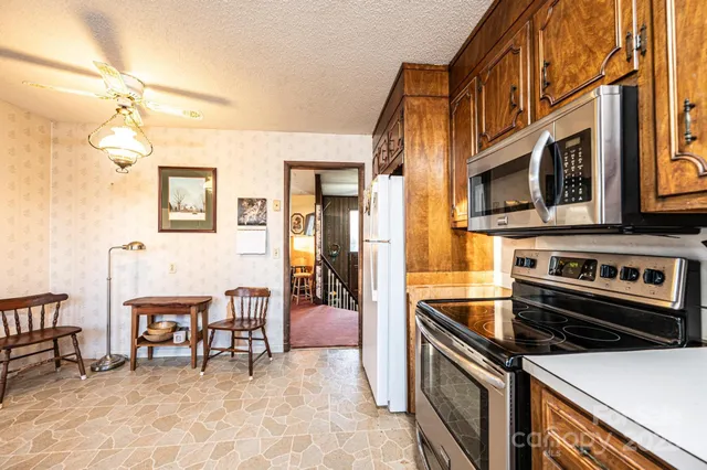 a kitchen with stainless steel appliances a stove a sink and a refrigerator
