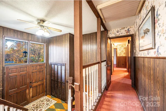 a view of a hallway with wooden floor and staircase