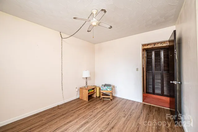 a view of a room with wooden floor