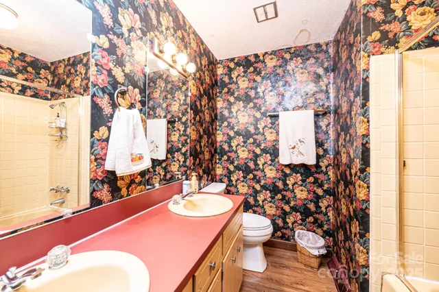 a bathroom with a sink toilet and mirror