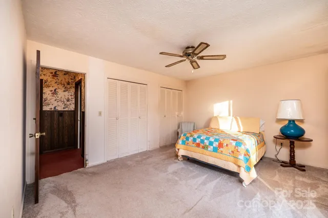 a bedroom with a bed and a lamp on table