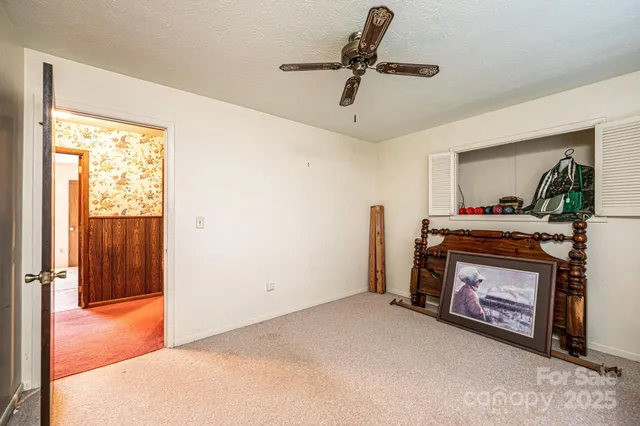 a view of an empty room with a fireplace and a window