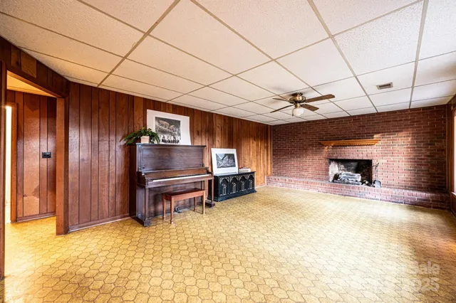 a view of an empty room with furniture and a window