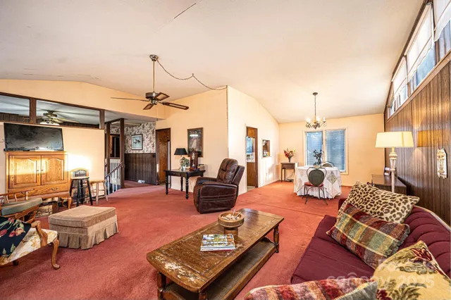 a living room with furniture fireplace and a table
