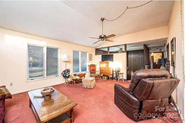 a living room with furniture and floor to ceiling windows