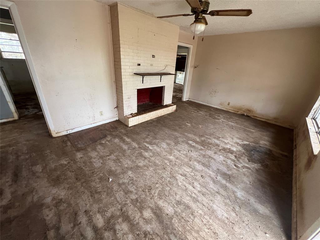 492 Richerson Road Denison, TX 75021 - Photo 5 of 29 a view of a livingroom with a fireplace and a ceiling fan