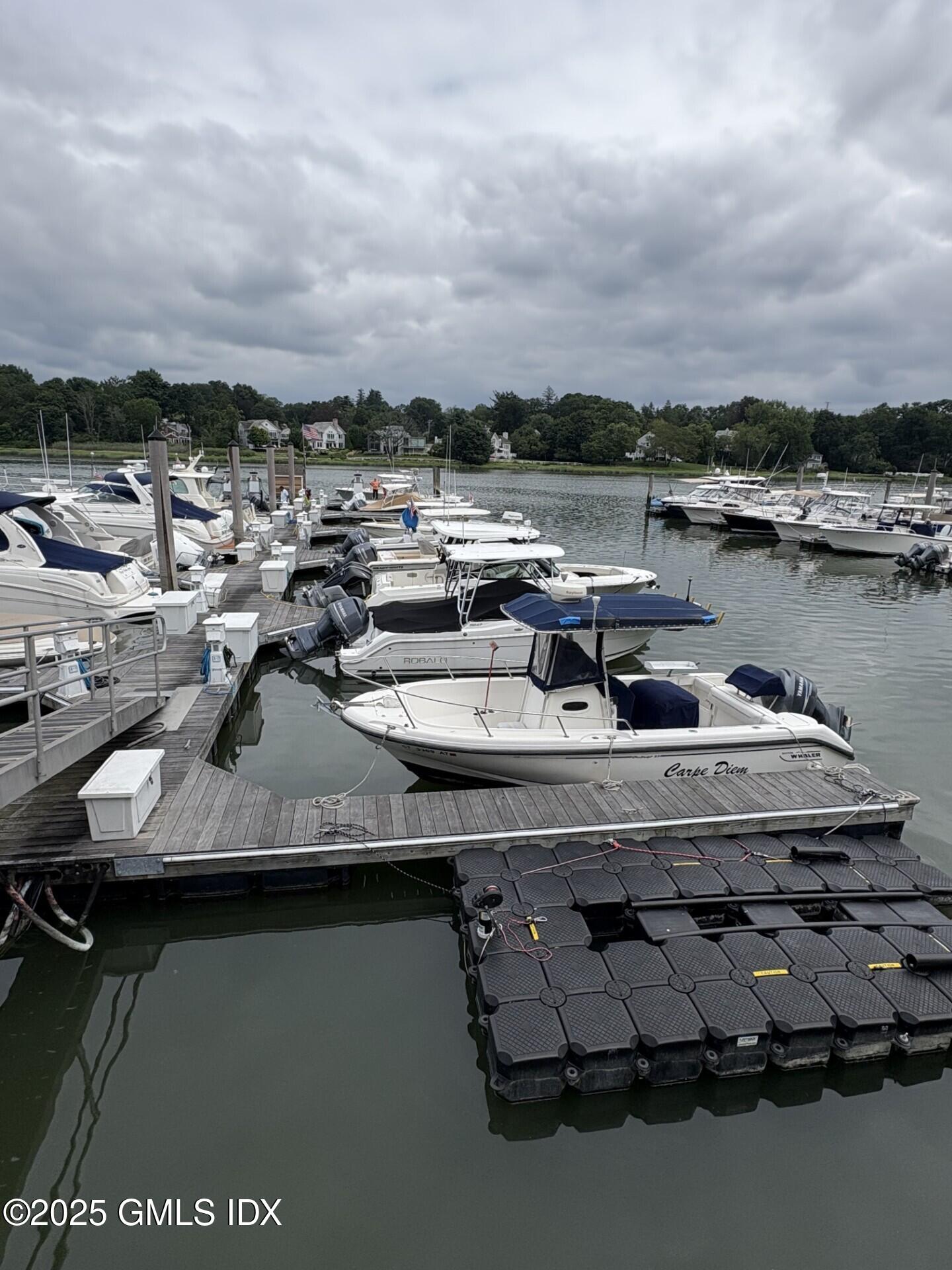 7 River Road, Unit BOAT SLIP A2 Cos Cob, CT 06807 - Photo 6 of 7 a view of a lake with houses in the back