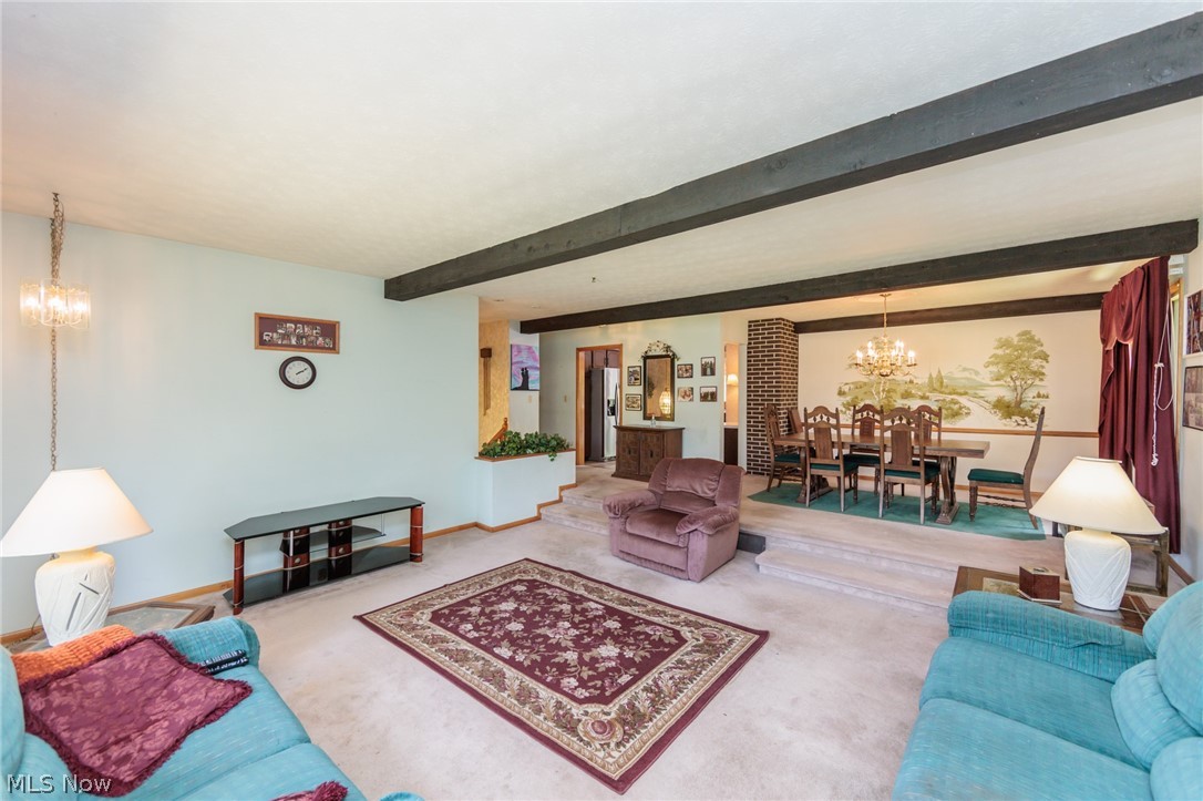2170 Norton Road Stow, OH 44224 - Photo 25 of 48 Spacious living area featuring exposed ceiling beams and light-toned carpeting