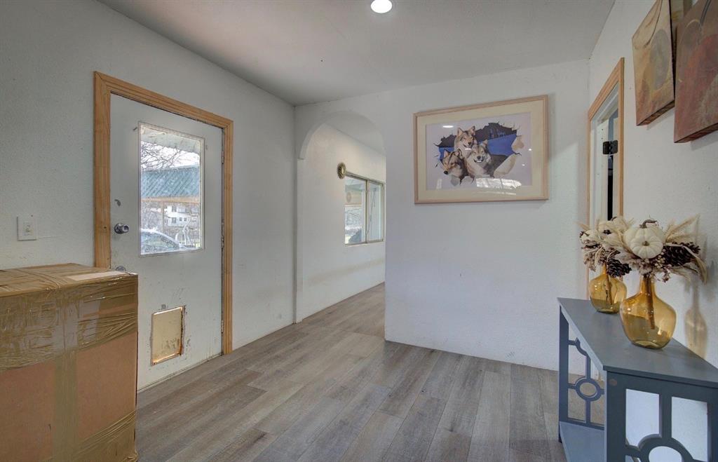 a view of a workspace with furniture and wooden floor