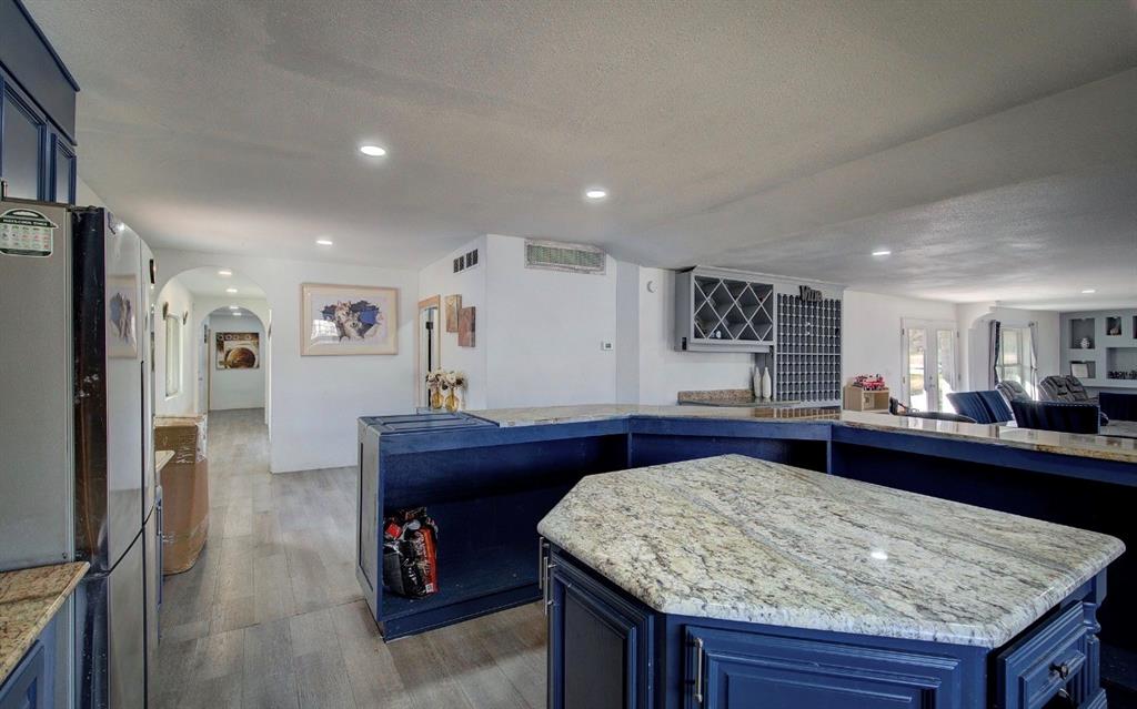 11291 Goss Street Wills Point, TX 75169 - Photo 11 of 23 a kitchen with granite countertop sink and refrigerator