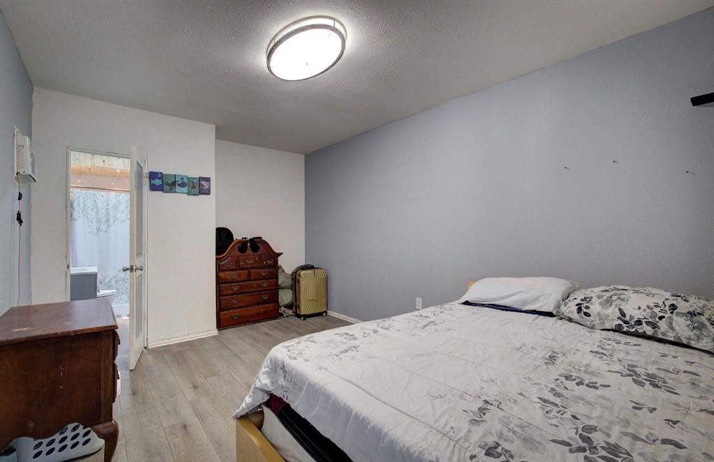 11291 Goss Street Wills Point, TX 75169 - Photo 16 of 23 a bedroom with a bed and wooden floor
