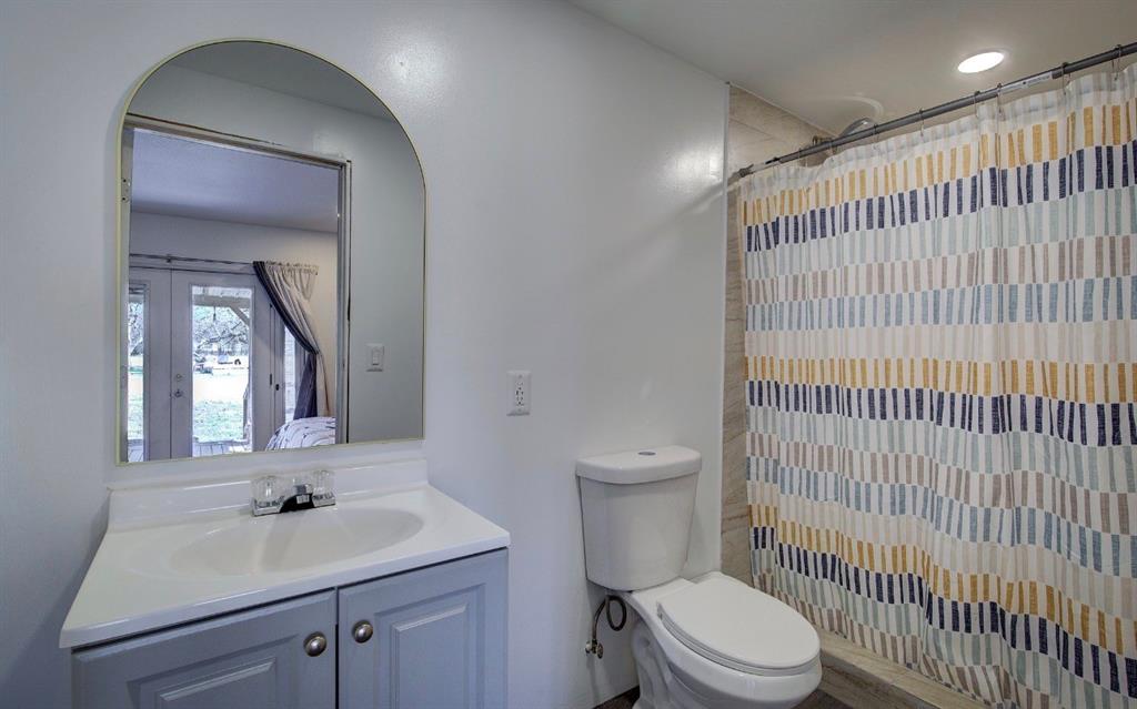 11291 Goss Street Wills Point, TX 75169 - Photo 17 of 23 a bathroom with a sink toilet vanity and mirror