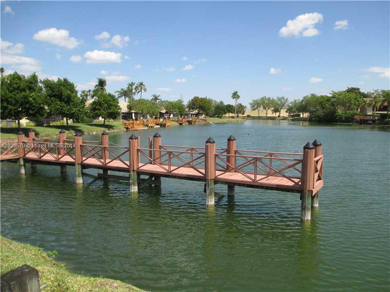 745 Banks Road, Unit 745 Margate, FL 33063 - Photo 11 of 13 a view of a lake with houses in the back