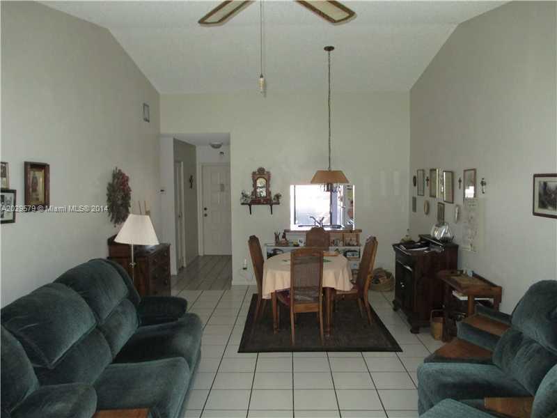 745 Banks Road, Unit 745 Margate, FL 33063 - Photo 2 of 13 a living room with furniture and a chandelier