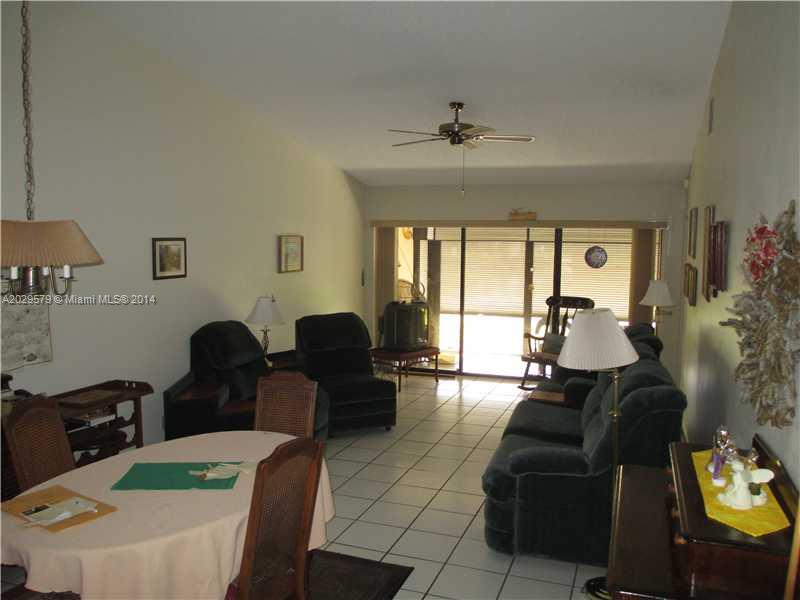 745 Banks Road, Unit 745 Margate, FL 33063 - Photo 4 of 13 a living room with furniture and a chandelier