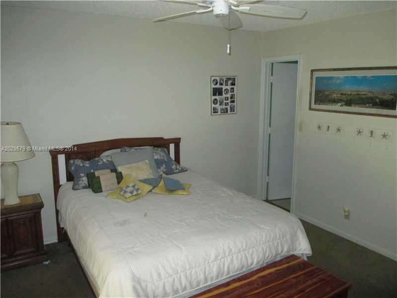 745 Banks Road, Unit 745 Margate, FL 33063 - Photo 5 of 13 a large bed sitting in a bedroom next to a window