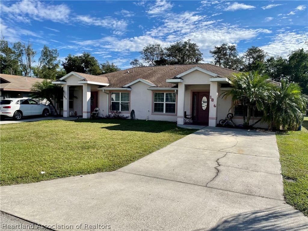 1812 Wightman Avenue Sebring, FL 33870 - Photo 1 of 22 a view of a house with a garden