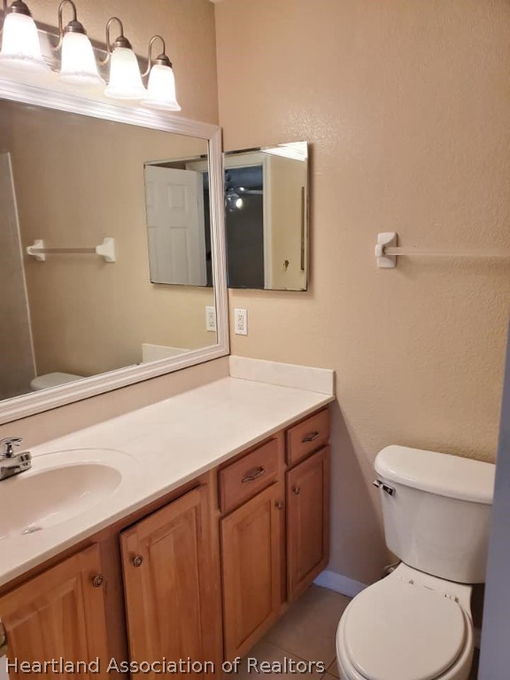 1812 Wightman Avenue Sebring, FL 33870 - Photo 16 of 22 a bathroom with a sink a toilet and mirror