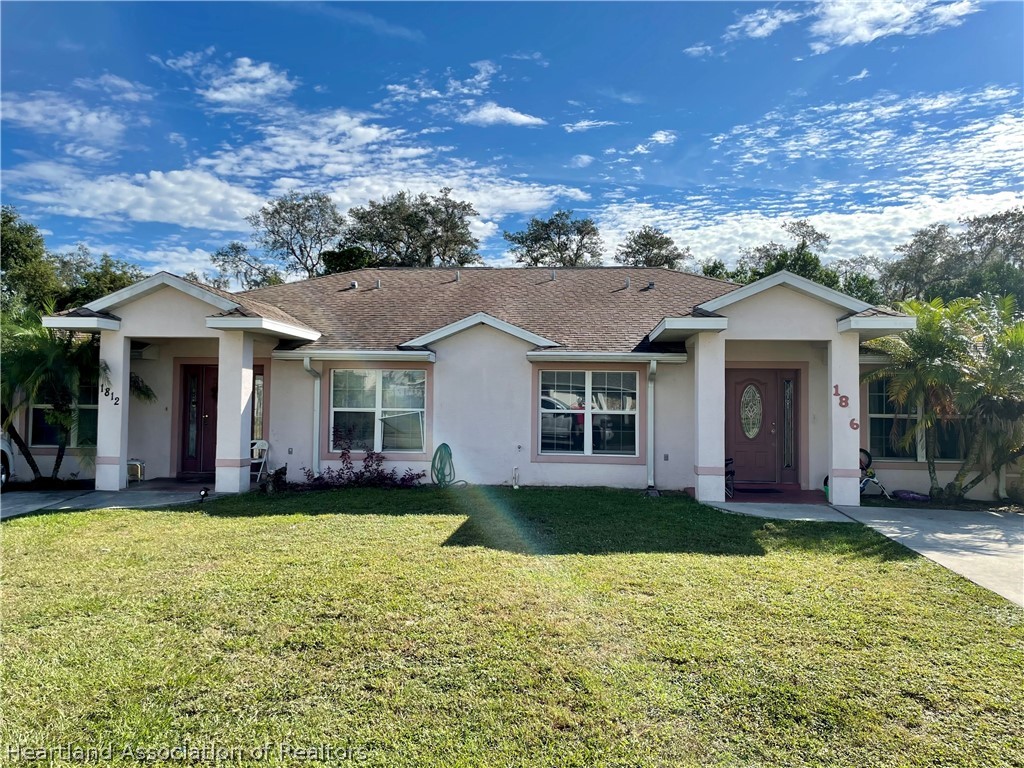 1812 Wightman Avenue Sebring, FL 33870 - Photo 2 of 22 front view of a house with a yard