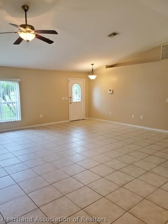 1812 Wightman Avenue Sebring, FL 33870 - Photo 6 of 22 an empty room with windows and ceiling fan