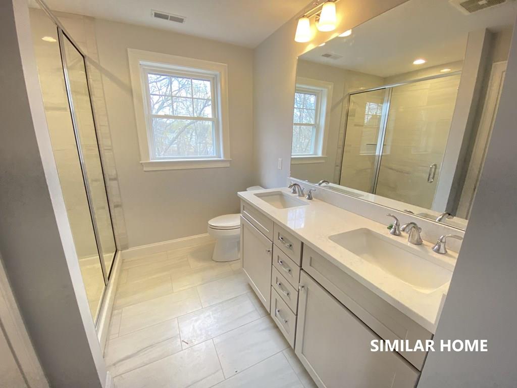 2 Braemore Road Billerica, MA 01821 - Photo 5 of 6 a spacious bathroom with double vanity sink a mirror and a shower