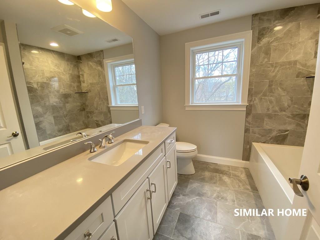 2 Braemore Road Billerica, MA 01821 - Photo 6 of 6 a bathroom with a double vanity sink a toilet and a bathtub