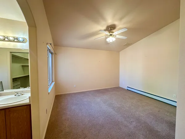 a view of a hallway with a chandelier fan