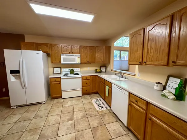 a kitchen with stainless steel appliances granite countertop a refrigerator sink and cabinets