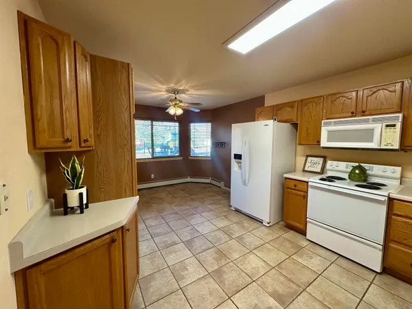 a kitchen with a refrigerator sink and stove