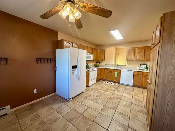 a kitchen with stainless steel appliances a refrigerator and a stove top oven