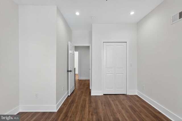 a view of hallway with wooden floor